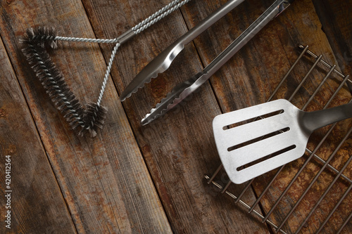 Premium perfect tools for for cooking on an open fire on wooden background. BBQ concept.
