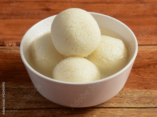 Indian Rasgulla or dry Rosogulla dessert / sweet served in a bowl. selective focus photo