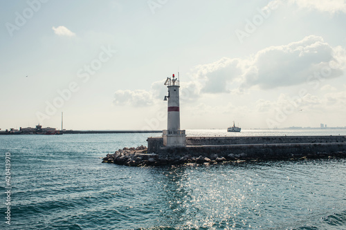 Lighthouse on pier with sea and sky at background in Istanbul, Turkey
