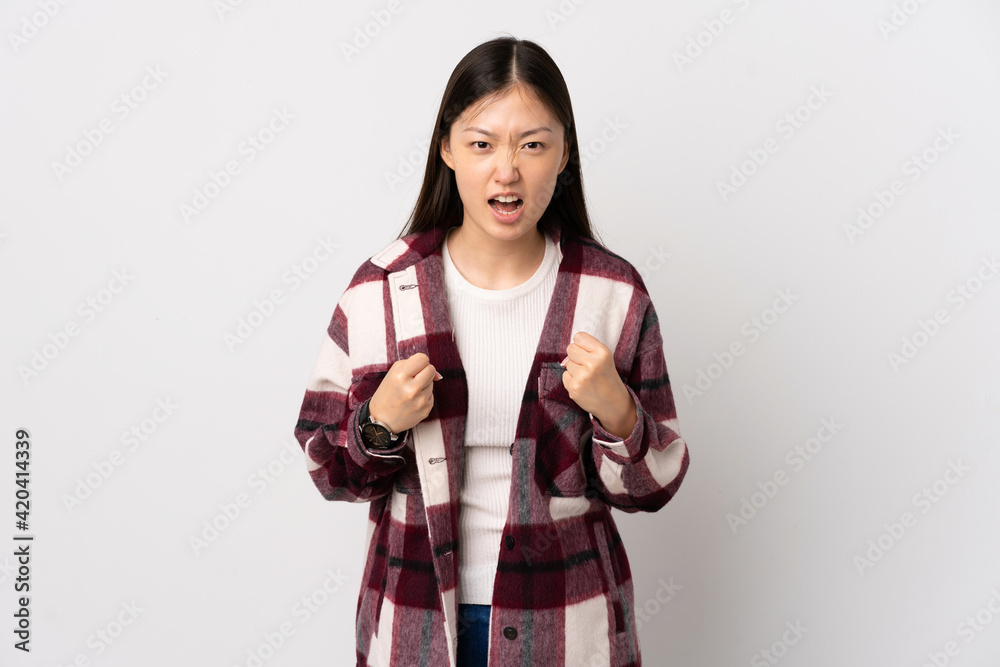 Young Chinese girl over isolated white background frustrated by a bad situation Young Chinese girl over isolated white background frustrated by a bad situation