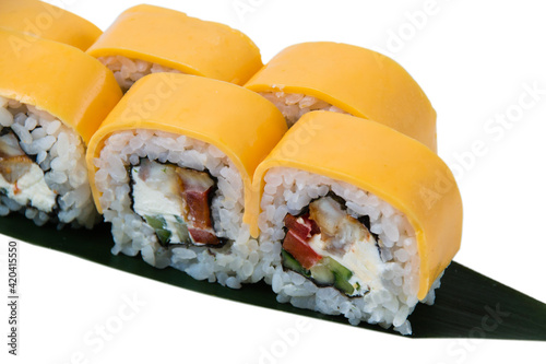 Sushi rolls with eel, cream cheese, cheddar cheese, cucumber, sweet pepper and nori on a white background