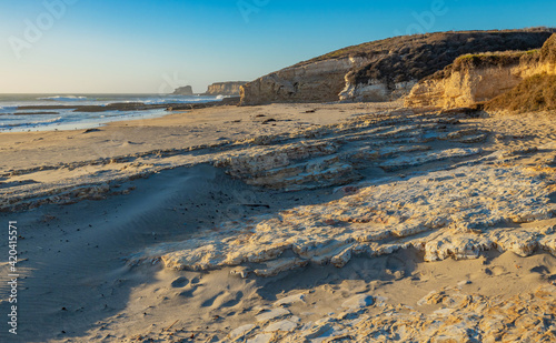 Beautiful landscapes of the Pacific coast  beach with human footprints  rocks  waves  sky  sun. Santa Cruz and Davenport have some of the most beautiful beaches in California.