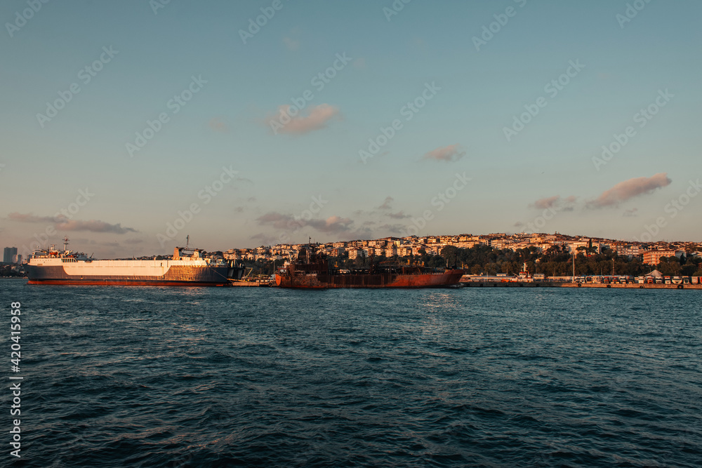Ships near seafront and Istanbul city during sunset, Turkey