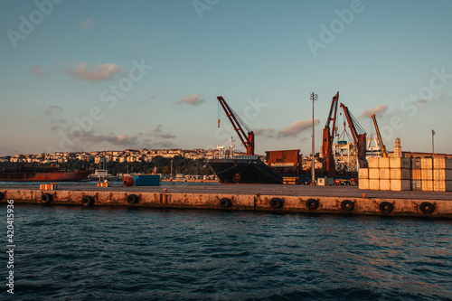 Heavy machinery in sea port of Istanbul during sunset, Turkey © LIGHTFIELD STUDIOS