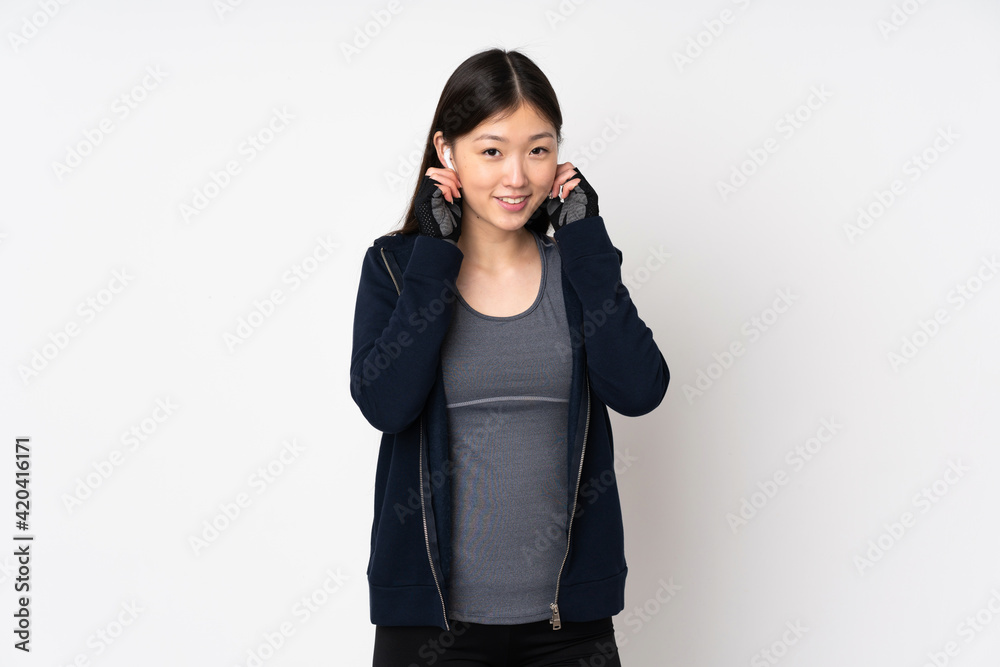 Young sport asian woman isolated on white background listening music Young sport asian woman isolated on white background listening music