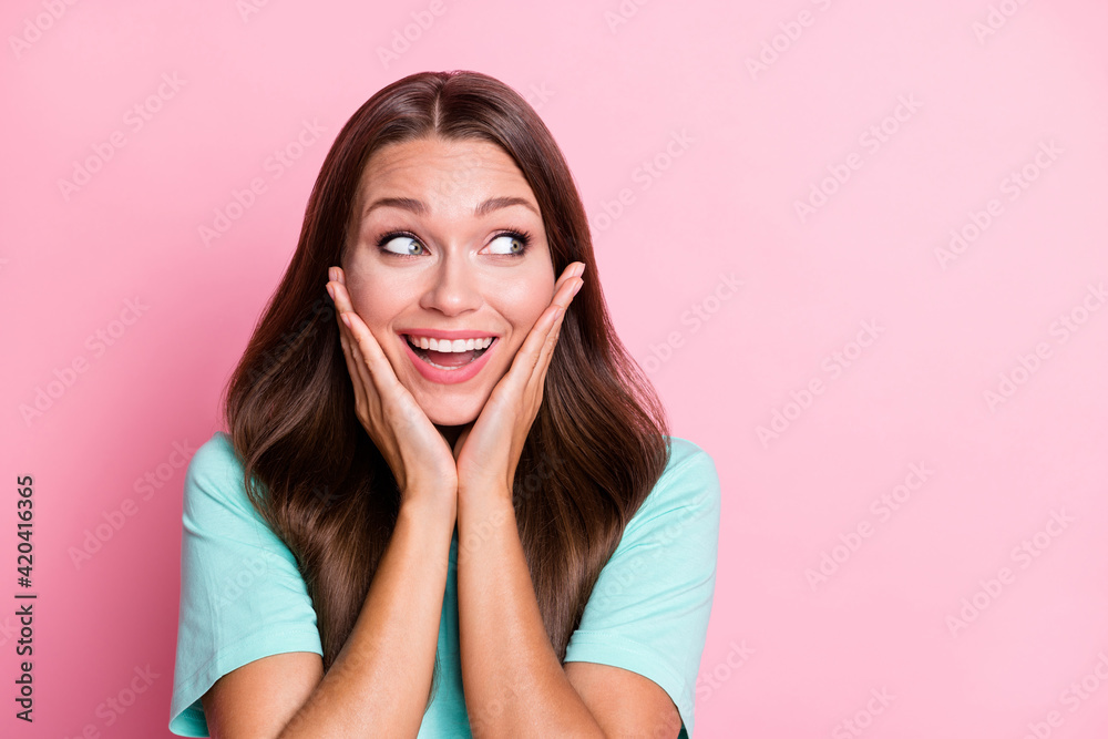 Photo portrait of impressed curious woman looking blank space touching face isolated on pastel pink color background Photo portrait of impressed curious woman looking blank space touching face isolated on pastel pink color background