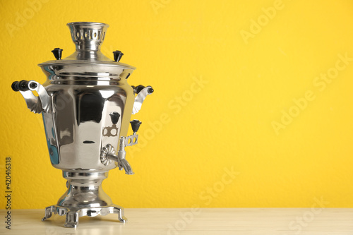 Photos Traditional Russian samovar on yellow background. Space for text
