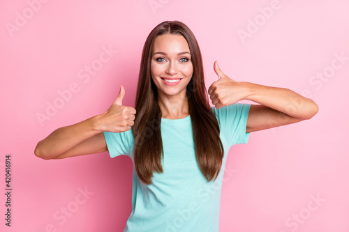 Photo portrait of funny female student showing like thumb-up gesture both hands isolated on pastel pink color background
