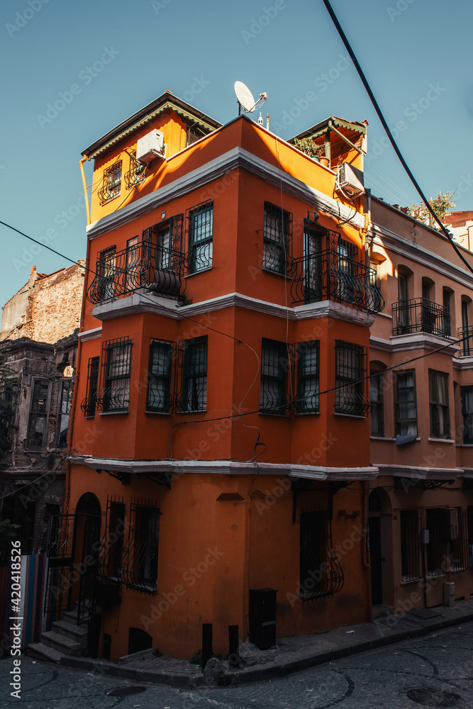 red, authentic building with fenced windows and balconies in Balat quarter, Istanbul, Turkey