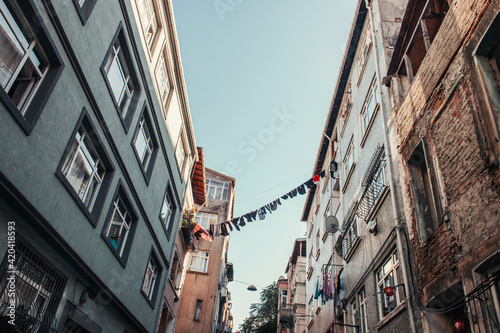 Clothesline with laundry between modern and old buildings in Balat quarter, Istanbul, Turkey