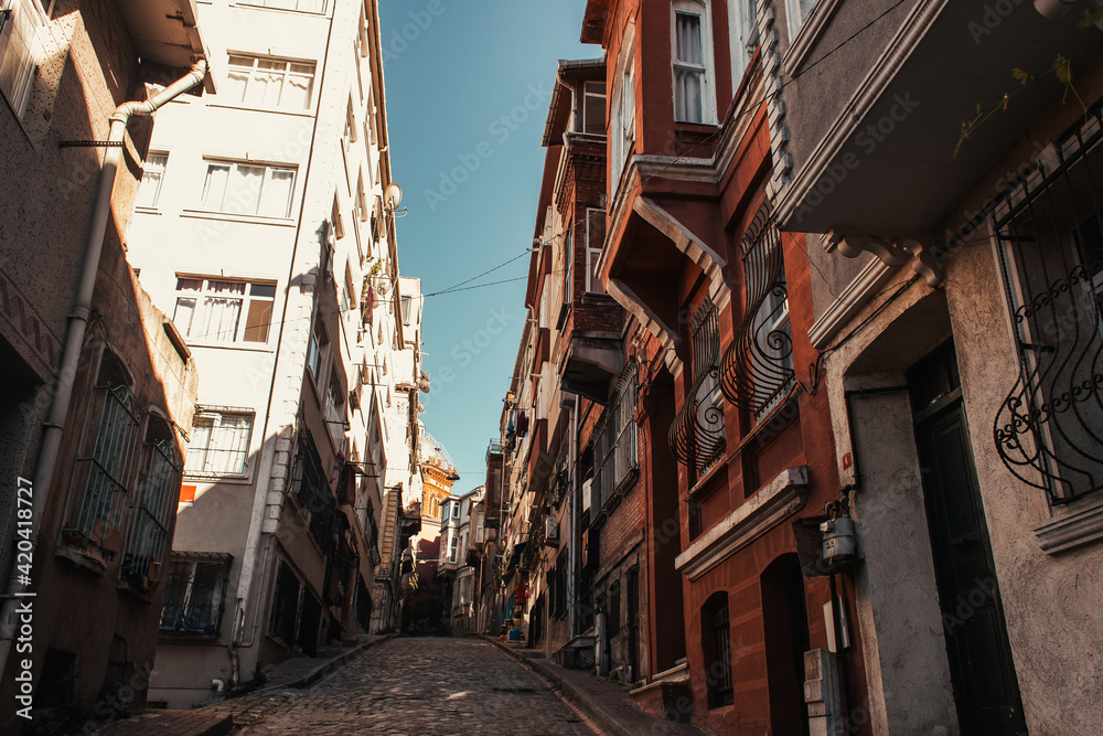 narrow street with contemporary and old buildings in Balat, Istanbul, Turkey
