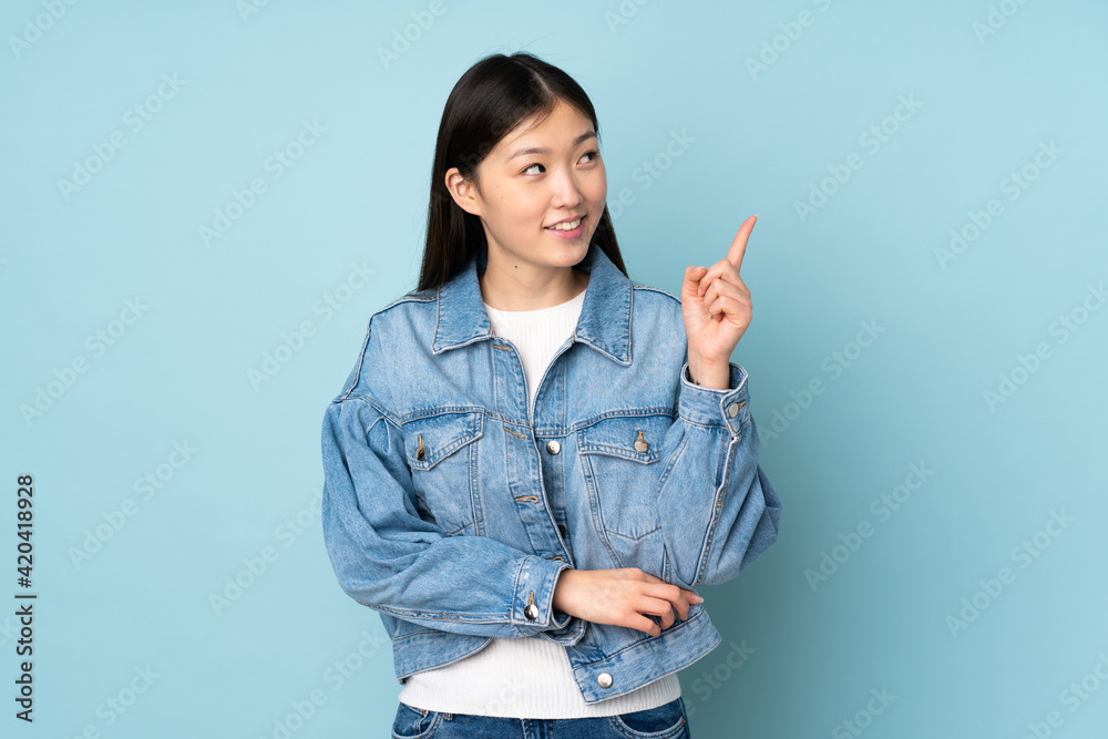 Young asian woman isolated on background pointing up a great idea Young asian woman isolated on background pointing up a great idea