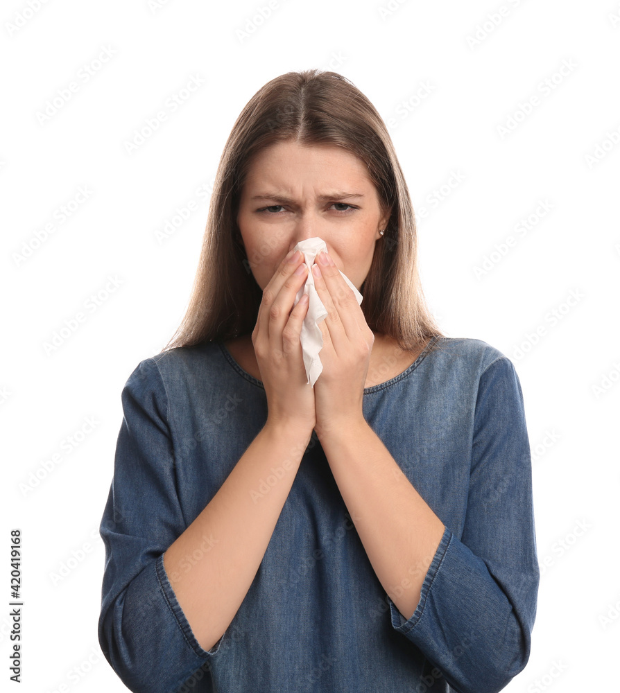 Young woman with tissue suffering from runny nose on white background Young woman with tissue suffering from runny nose on white background