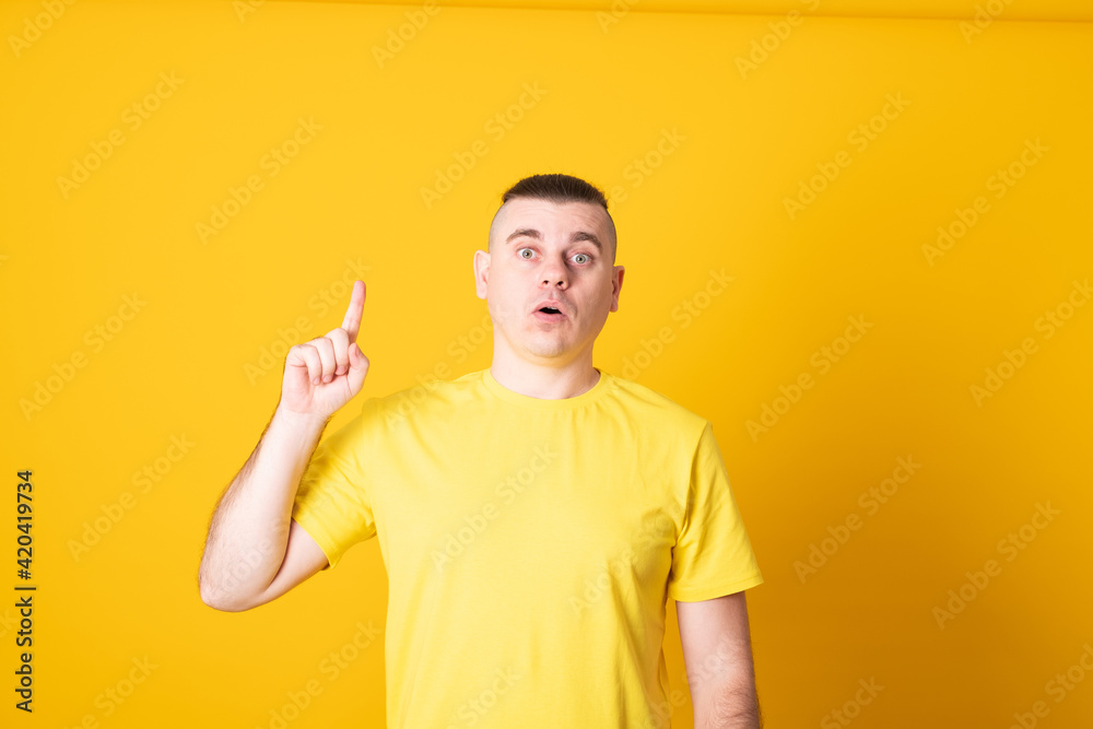 Young man having a good idea. Man showing and pointing up with finger number one while smiling confident and happy. Young man having a good idea. Man showing and pointing up with finger number one while smiling confident and happy.