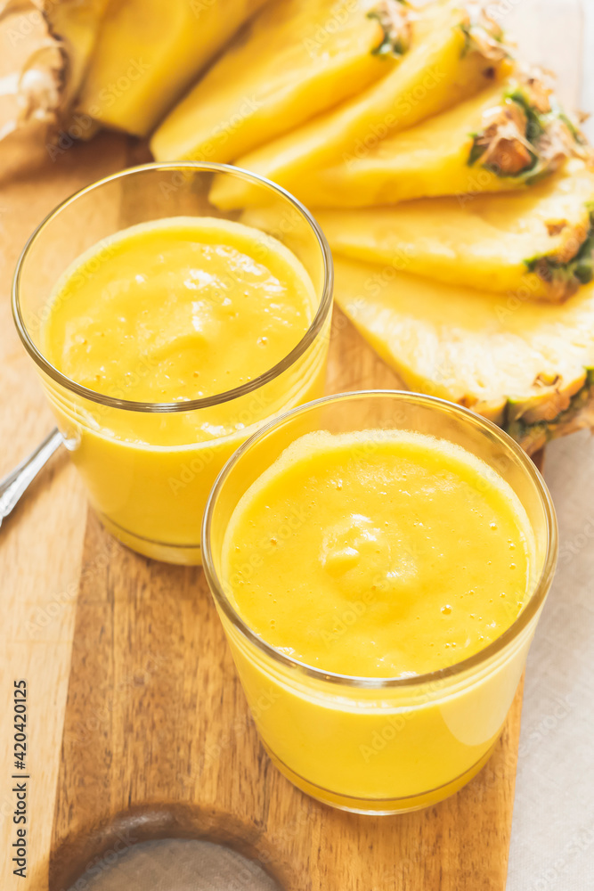 Fresh pineapple smoothies on the table. Morning light healthy breakfast with organic pineapple fruit Fresh pineapple smoothies on the table. Morning light healthy breakfast with organic pineapple fruit