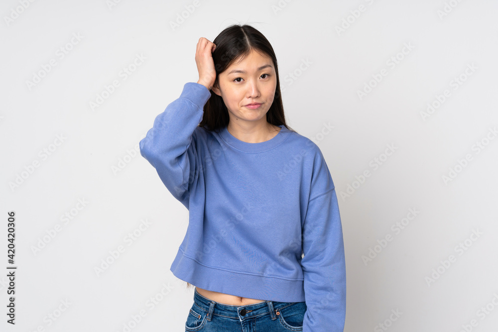 Young asian woman isolated on background with an expression of frustration and not understanding Young asian woman isolated on background with an expression of frustration and not understanding