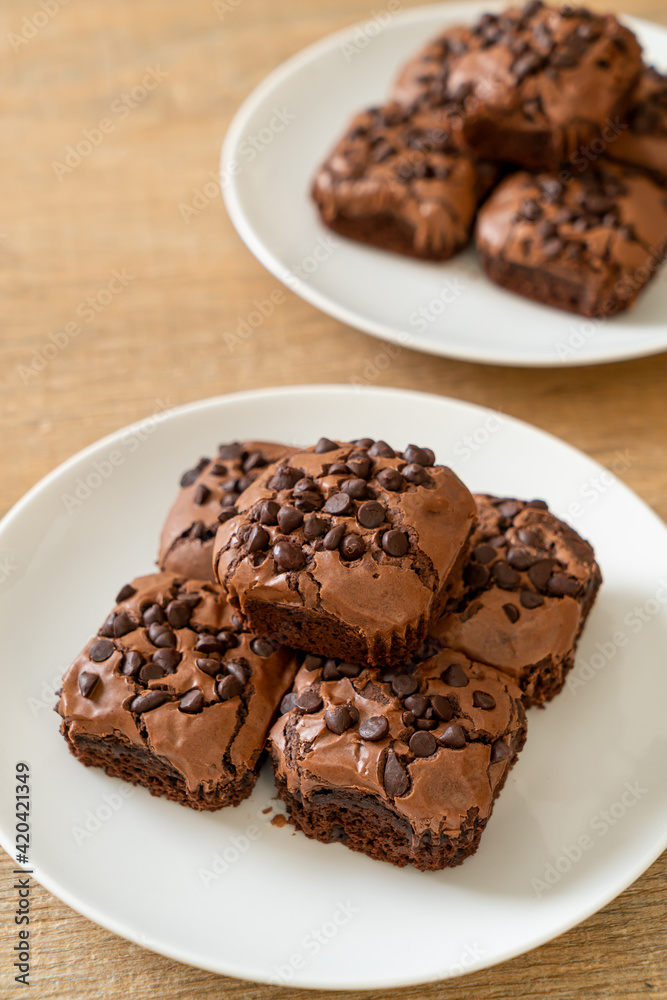 dark chocolate brownies topped by chocolate chips