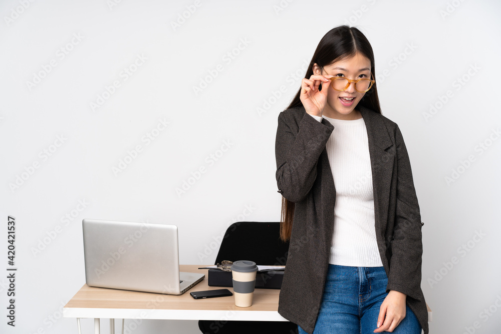 Business asian woman in her workplace isolated on white background with glasses and happy Business asian woman in her workplace isolated on white background with glasses and happy