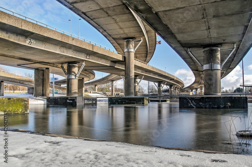 Rotterdam, The Netherlands, February 10, 2020: view of the concrete overpasses on Kleinpolderplein junction reflecting on the icy surface underneath photo