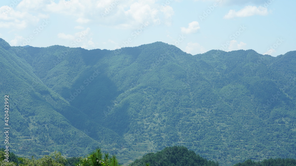 The beautiful countryside view in the southern China with the green mountains as background