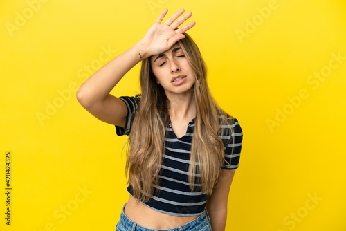 Young caucasian woman isolated on yellow background with tired and sick expression