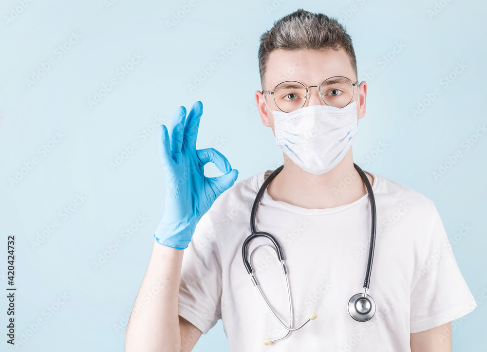 Covid-19, preventing virus, healthcare and vaccination concept. Happy smiling doctor in medical mask and gloves assure all good, show okay sign as guarantee safety and quality of service in clinic Covid-19, preventing virus, healthcare and vaccination concept. Happy smiling doctor in medical mask and gloves assure all good, show okay sign as guarantee safety and quality of service in clinic