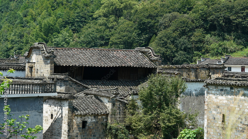 The old traditional Chinese architecture located in the countryside of southern China with the black tiles roof and white wall