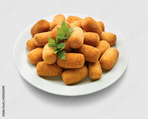 croquetas  caseras  de jamón ibérico en plato sobre fondo blanco. Homemade iberian ham croquettes on plate on white background.