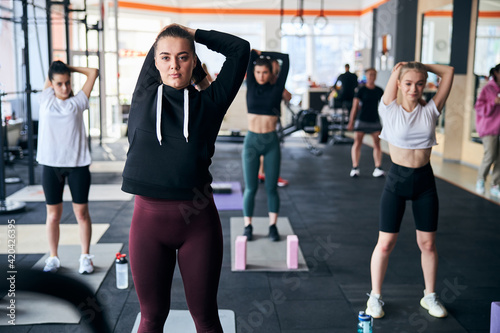 Fit ladies exercising as a group at the gym