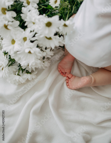 newborn and flowers