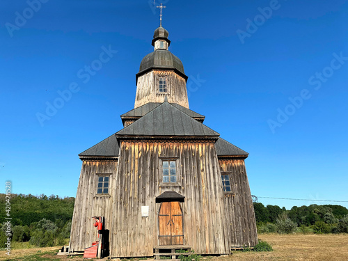 Beautiful Mykolaiv church, old 18th century church, an architectural monument of Ukraine, Authentic Cossack farm in Stetsivka village in Сherkasy region. Cossack wooden church in the village.  photo