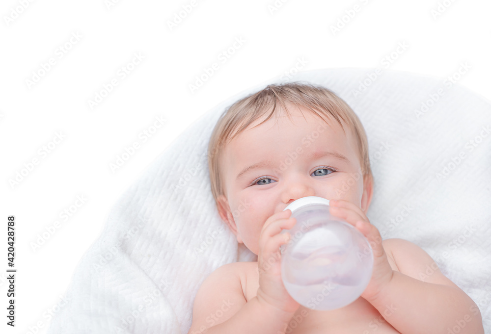 The baby drinks from the bottle