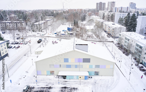 Obraz na płótnie Aerial view of Matinkyla neighborhood of Espoo, Finland. Snow-covered city in winter. On the foreground modern building of the kindergarten. w salonie