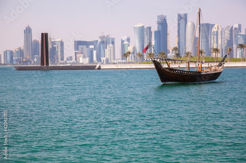 Traditional dhow boats with the futuristic skyline of Doha in the background, Qatar,12/23/2016
