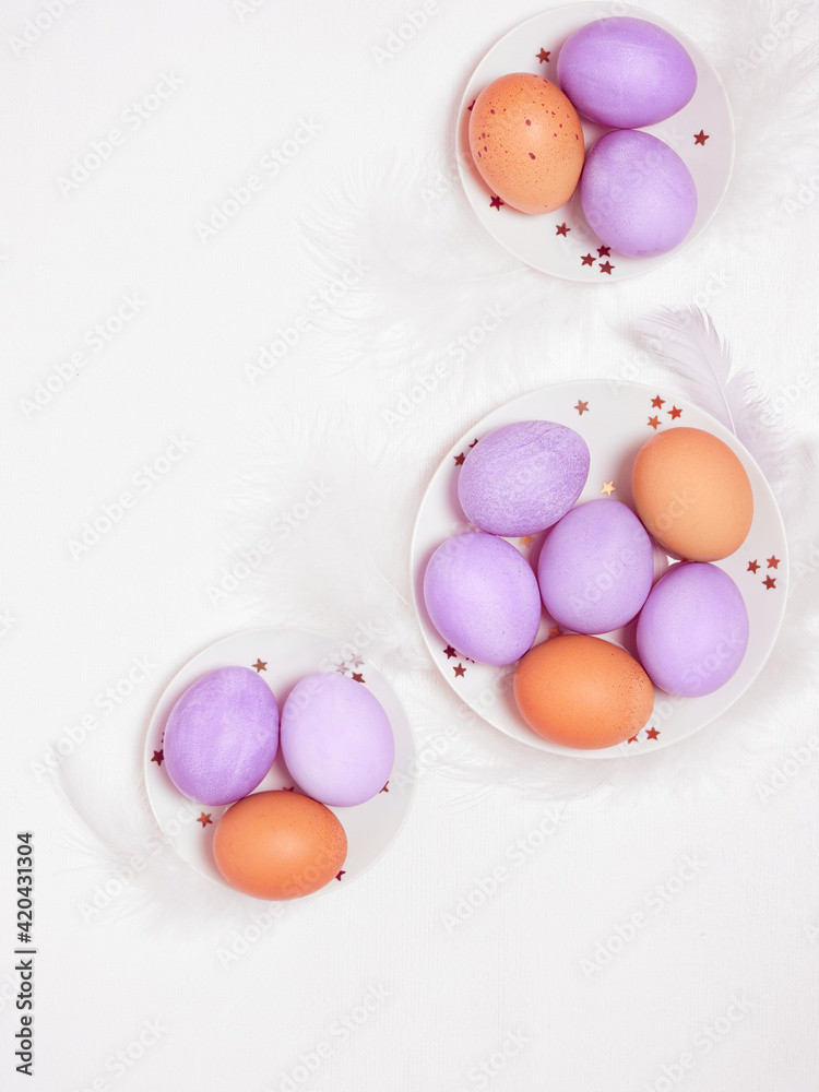 Colored eggs on plate with on white background. Flat lay. Copy space. Easter concept. Top view. Colored eggs on plate with on white background. Flat lay. Copy space. Easter concept. Top view.