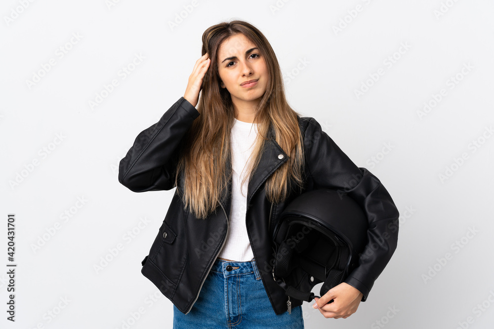 Young Woman holding a motorcycle helmet over isolated white background unhappy and frustrated with something. Negative facial expression Young Woman holding a motorcycle helmet over isolated white background unhappy and frustrated with something. Negative facial expression