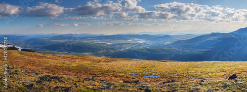 Panoramic view from the summit of the mountain valley in the morning light