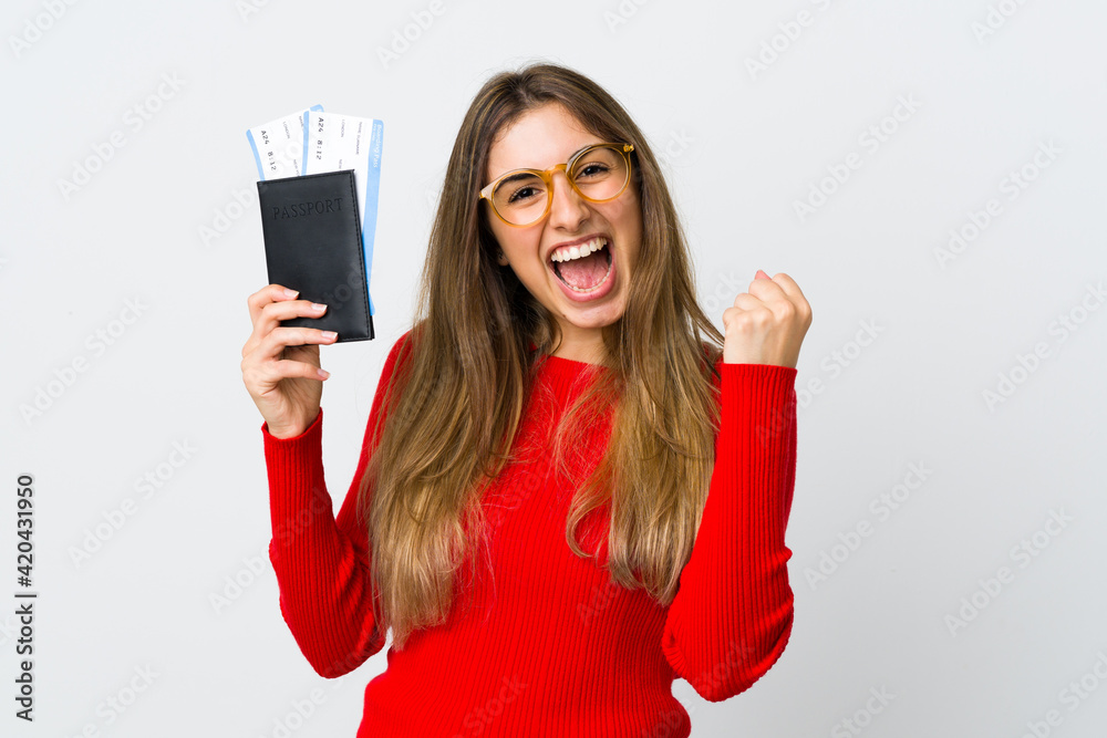 Young woman over isolated white background happy in vacation with passport and plane tickets Young woman over isolated white background happy in vacation with passport and plane tickets