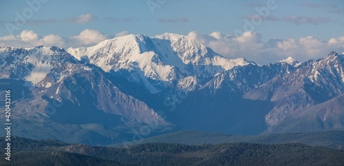 Snow capped mountain peaks on a summer morning