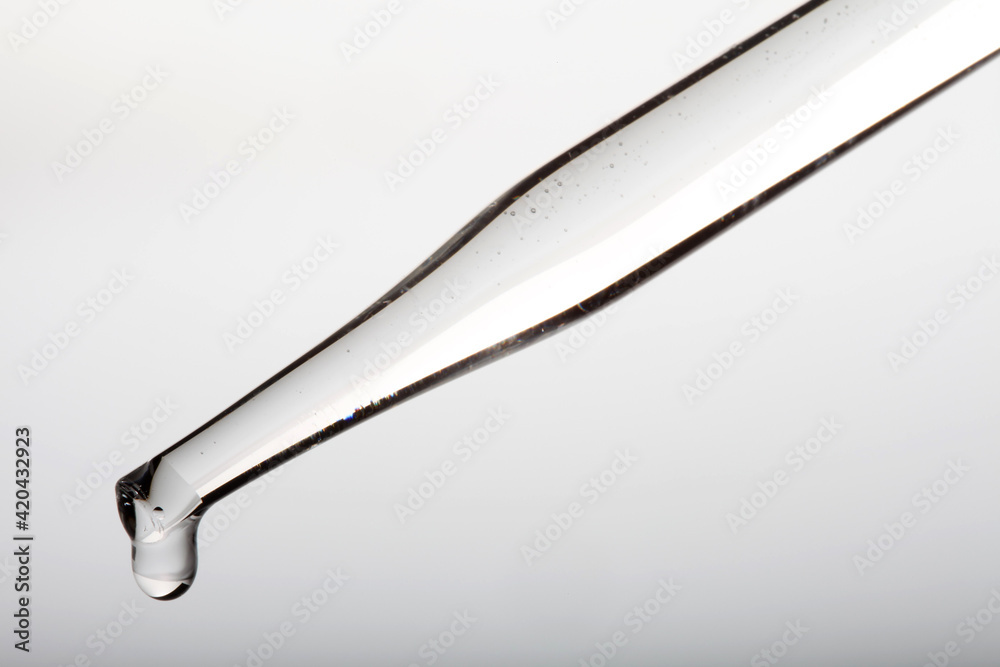 Pipette with clear liquid and droplet Pipette with clear liquid and droplet