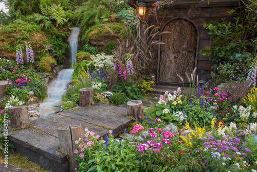 Fototapeta Naklejka Na Ścianę i Meble -  Landscaped backyard of old house with flower garden