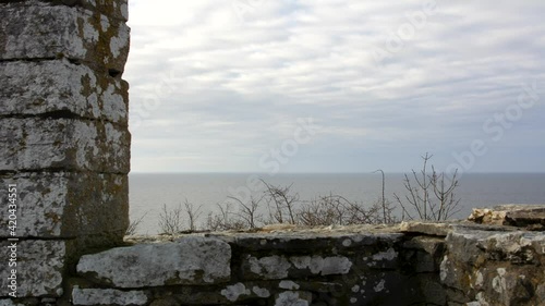 Clouds passing over medieval stone gallows in time lapse