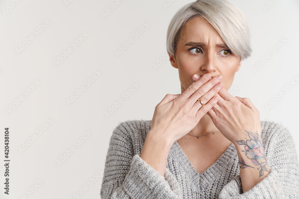 Displeased silver girl covering her mouth and looking aside Displeased silver girl covering her mouth and looking aside