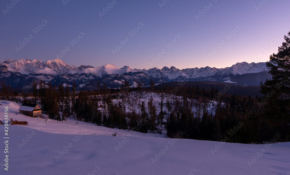 Scenic image of mountain landscape during sunset. Colorful sky over the snowcowered mountain and frozen landscape under vivid pink sunlight. Stunning nature background. Tatras zakopane poland