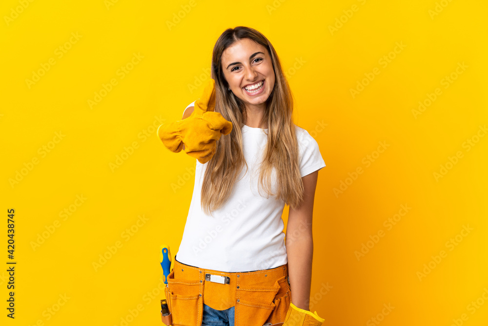 Young hispanic electrician woman over isolated yellow wall with thumbs up because something good has happened Young hispanic electrician woman over isolated yellow wall with thumbs up because something good has happened