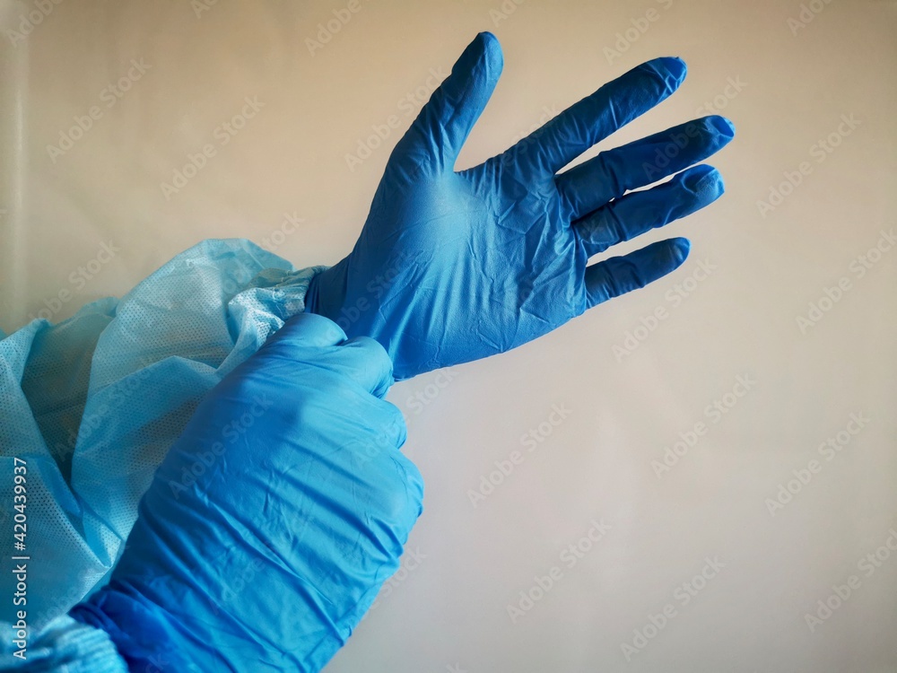 A man puts on medical gloves. Coronavirus protection. Personal protection. A man puts on medical gloves. Coronavirus protection. Personal protection.