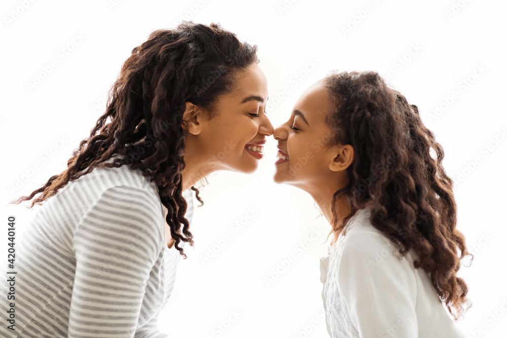 Mom and daughter touching each other with noses