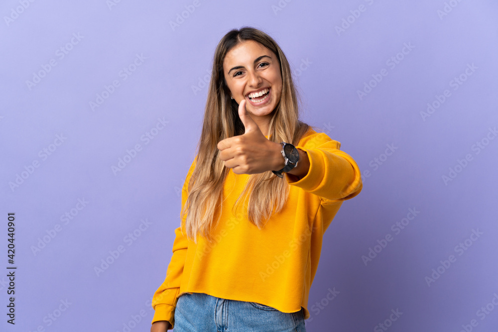 Young hispanic woman over isolated purple background with thumbs up because something good has happened Young hispanic woman over isolated purple background with thumbs up because something good has happened