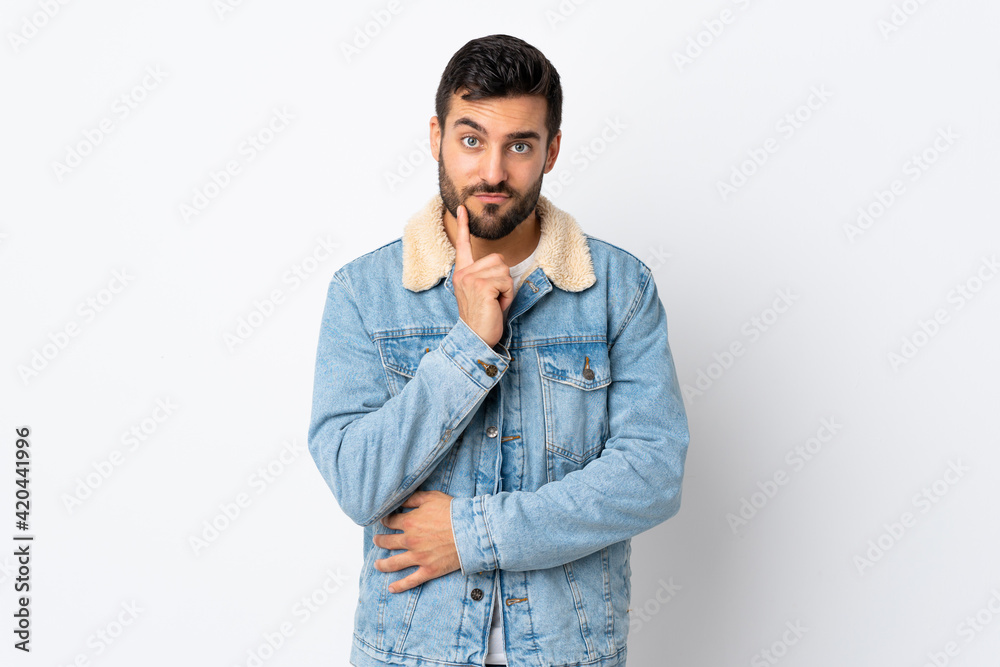 Fototapeta premium Young handsome man with beard isolated on white background and thinking