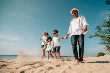 Asian family vacation at the beach with family relationships.Happy family travel on beach in holiday,Summer and vacations concept.